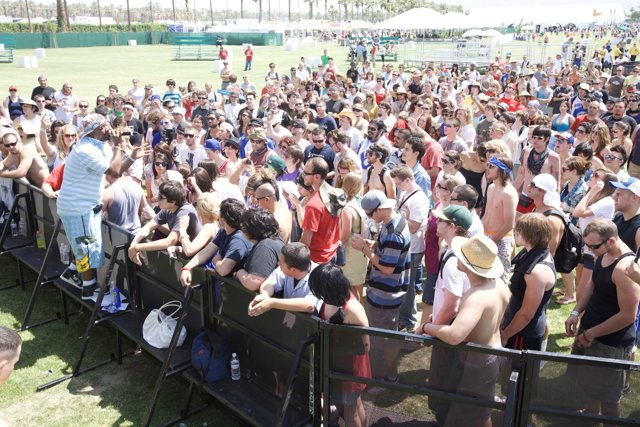 Coachella Crowd Gathers In Front of Fence