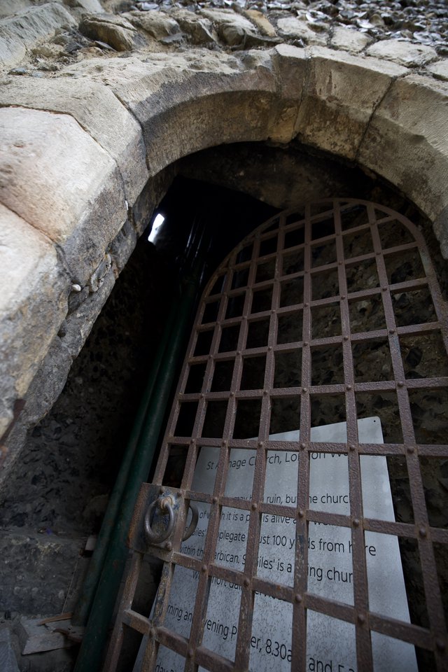 Ancient Stone Archway with Rusted Iron Gate