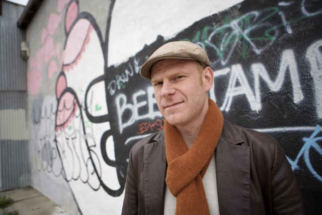 Junkie XL Poses in Front of Graffiti Wall