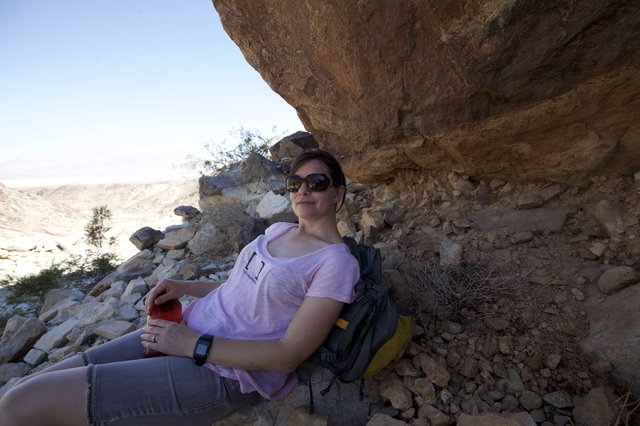 Desert Hiker Resting in Rocky Canyon Shade