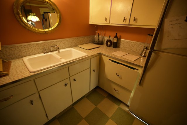 Retro Kitchen Corner with Orange Walls and Checkered Floor