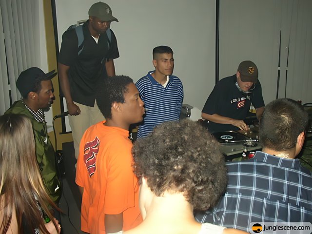 Crowd gathered around DJ at indoor venue