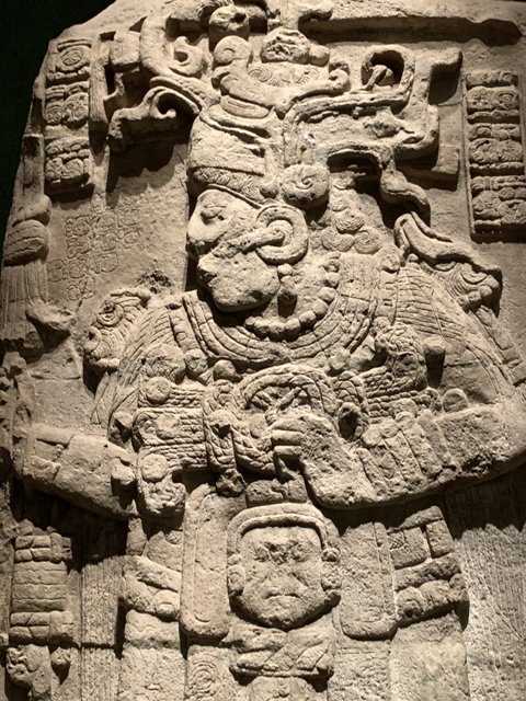 Ancient Stone Carving of a Headdressed Man in a Monastery