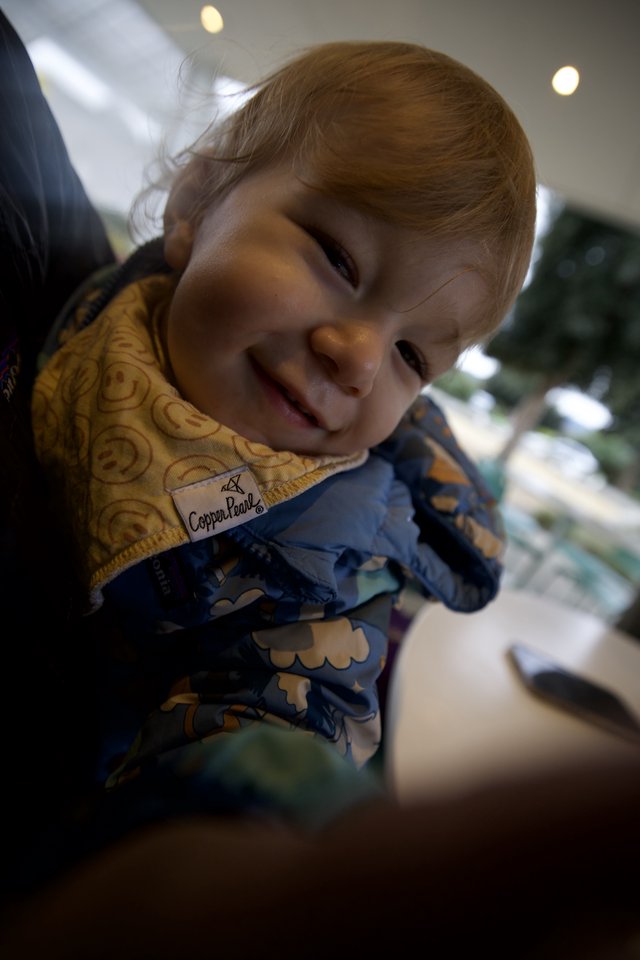 Joyful Toddler Smiling at Family Dinner