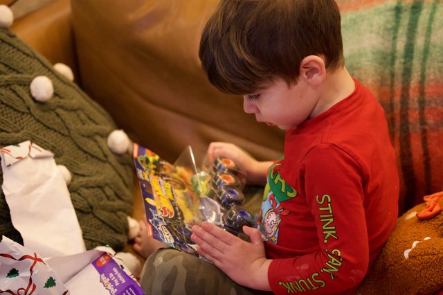 Child Opening LEGO Gift on Christmas Morning