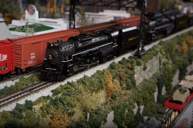 Three Toy Trains on Railway Tracks