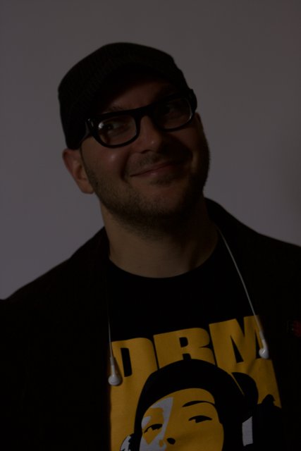 Smiling Man in Black Jacket and Glasses