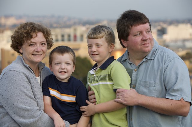 Family Portrait at Dusk with City Skyline