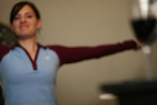 Woman Toasting with Red Wine Glass Outstretched