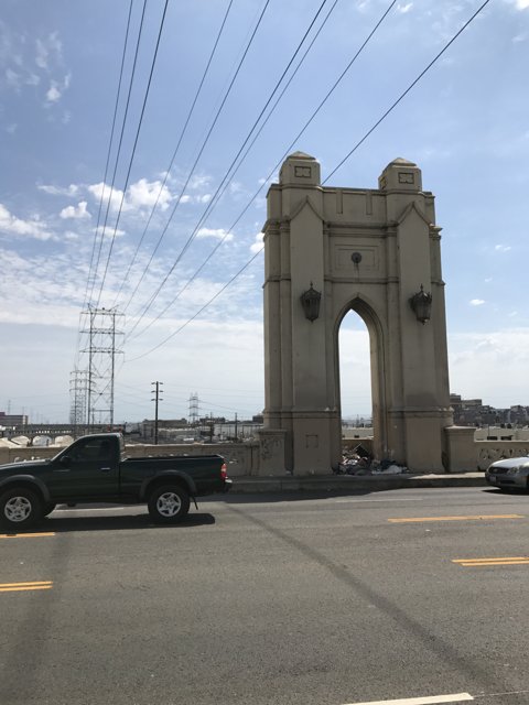 Pickup Truck Driving past Majestic Arch