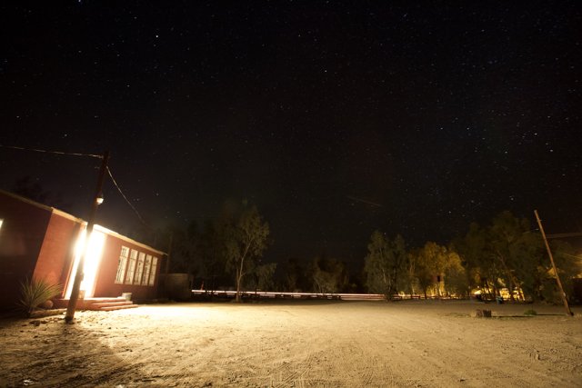 Cozy Red Hut Under the Starry Night Sky