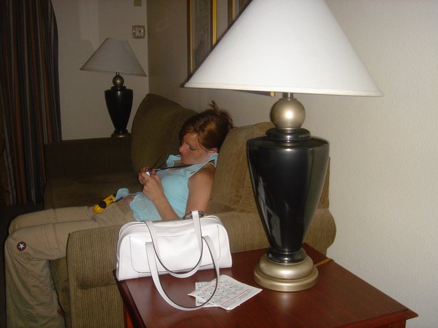 Woman Relaxing on Hotel Couch with Handheld Device