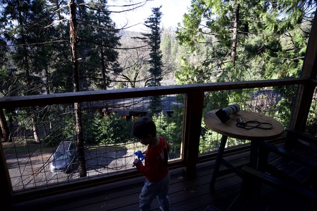 Child Playing on Mountain Cabin Deck at Sunset
