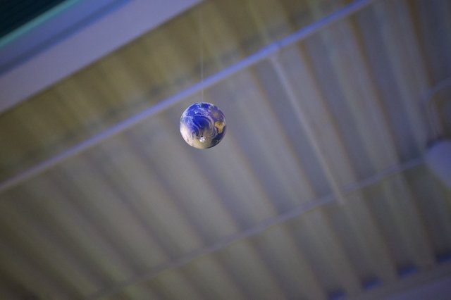 Earth Marble Suspended in Mid-Air Reflection