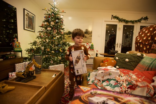 Child Opening Christmas Presents on Christmas Morning