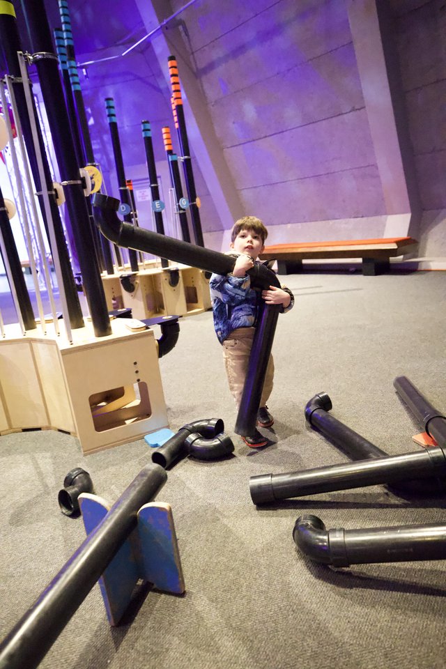 Young Boy Building with Foam Tubes at Interactive Museum
