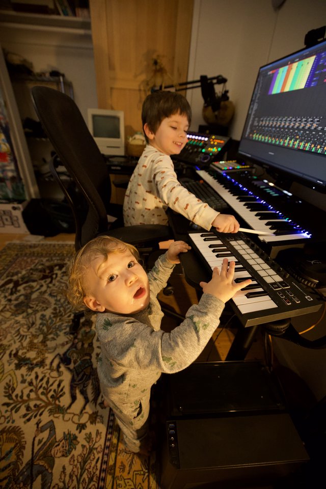 Two Young Children Playing Music Keyboard in Home Studio