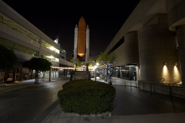 Orange Spaceship on City Sidewalk