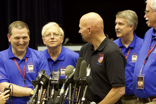 Media Briefing with Blue Shirted Men
