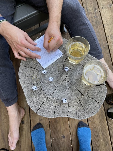 Man Playing Dice on Wooden Deck