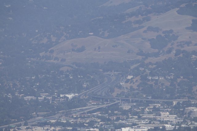 Hazy Interstate Interchange Beneath California's Rolling Hills