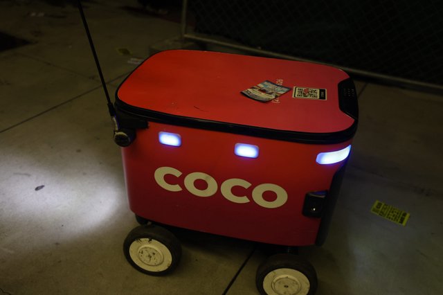 Coco Delivery Robot Navigating Nighttime Festival Grounds