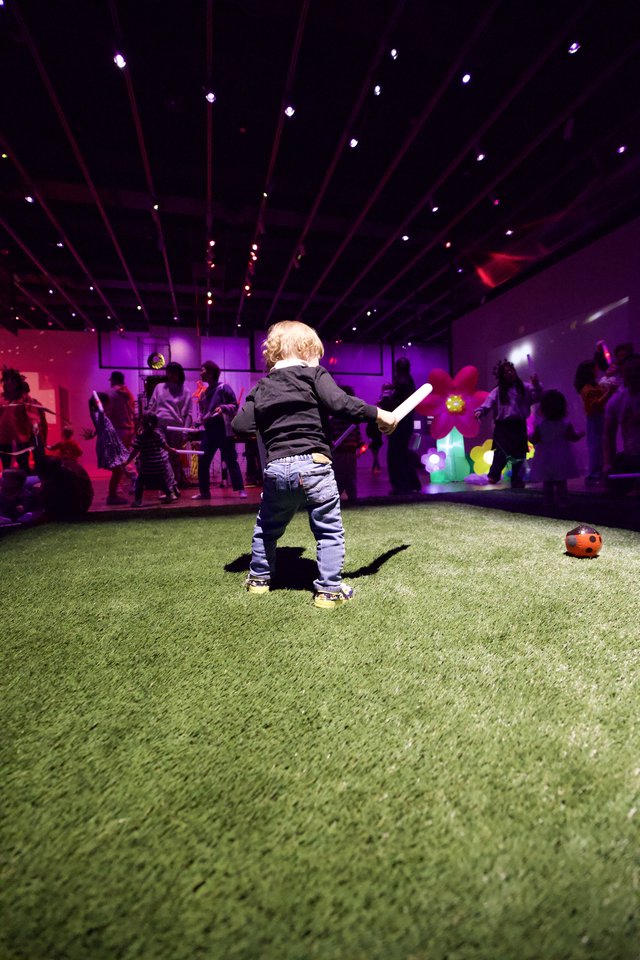 Toddler Playing at Baby Rave in Purple Neon Museum