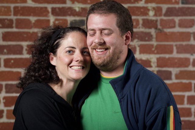 Smiling Couple in Front of Brick Wall