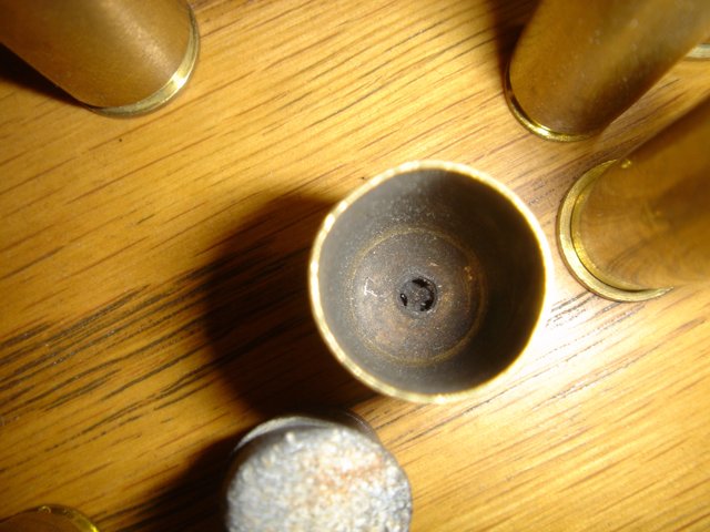 Brass Bullets on Hardwood Table