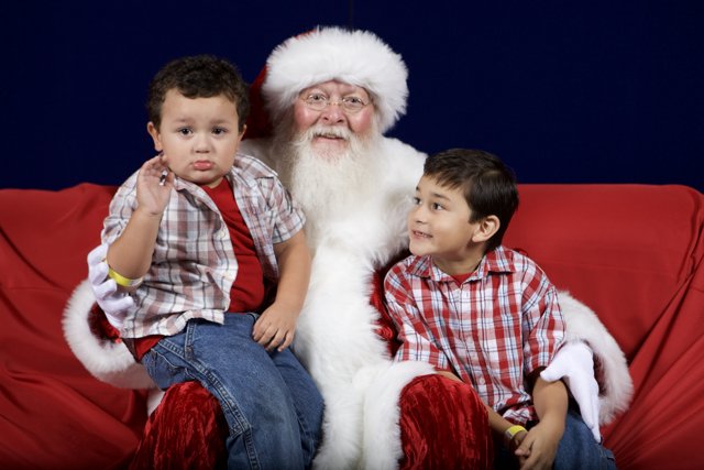 Santa Claus and Two Boys Sitting on Couch