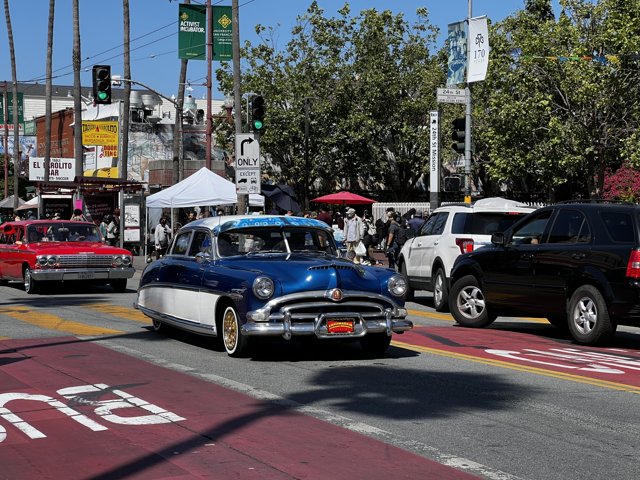 Vintage Car Cruising Through Crowded City Street