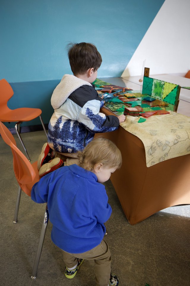 Children Exploring Interactive Exhibit at Play Space
