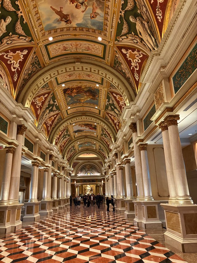 Ornate Barrel-Vaulted Gallery with Classical Columns and Frescoes