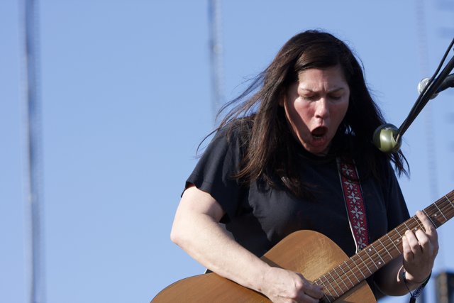 Kim Deal strums her acoustic guitar at Coachella 2008