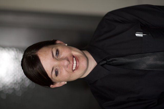 Smiling Woman in Black Uniform Portrait