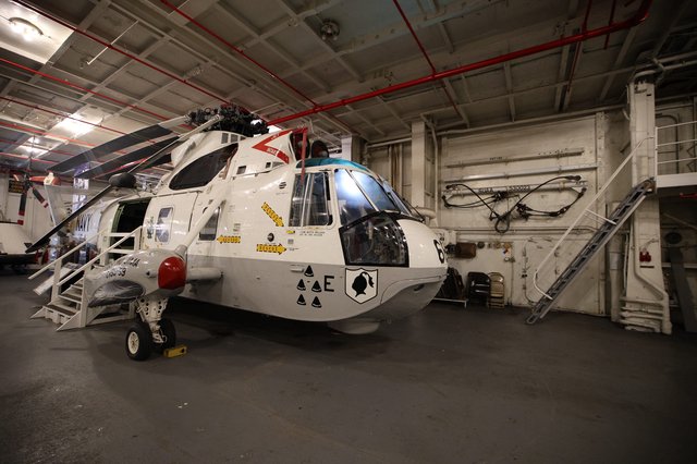 Military Helicopter in Aircraft Carrier Hangar Bay