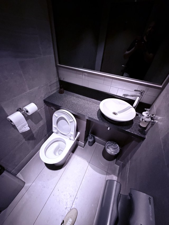 Modern Minimalist Bathroom with Dark Granite Countertops
