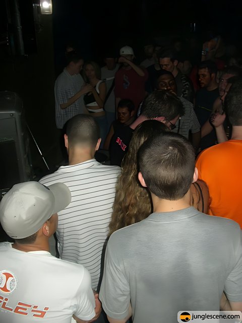 Crowd Gathered around Musician in Nightclub