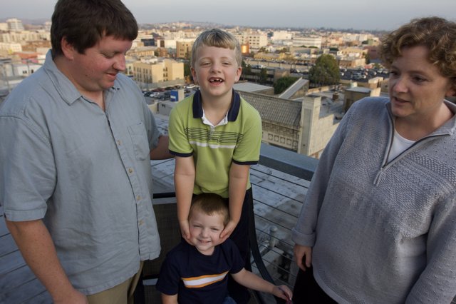 Family Rooftop Gathering at Dusk Over the City