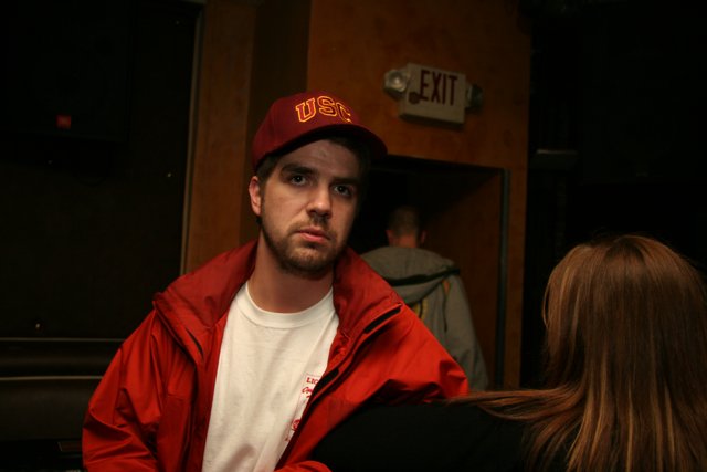 Red Jacket and Baseball Cap at the Pub