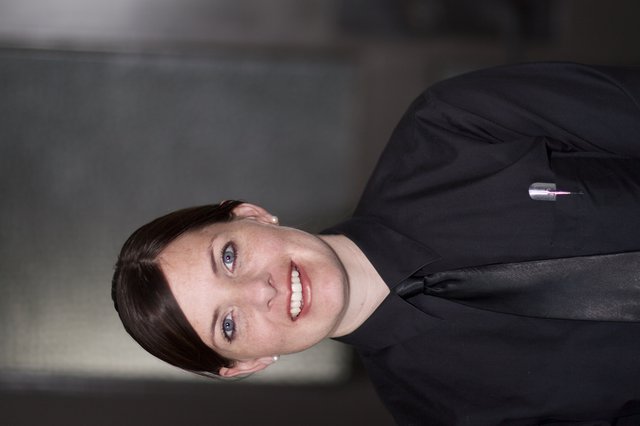 Professional Woman in Black Uniform Smiling Confidently
