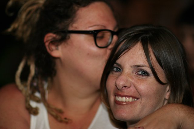Two Friends Share a Warm Embrace at Social Gathering