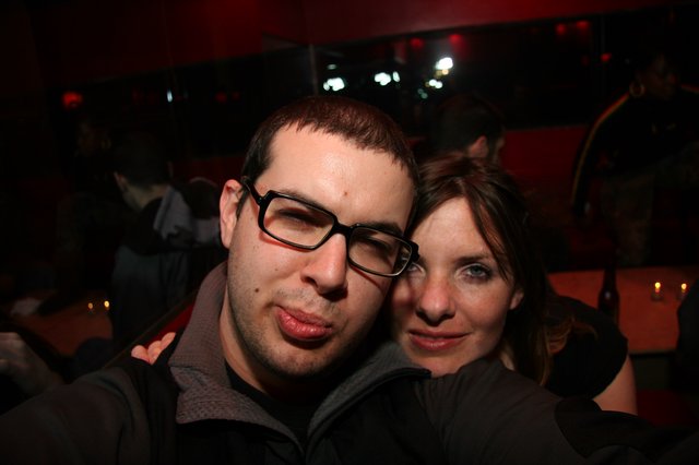 Friends Posing Together at a Dimly Lit Nightclub