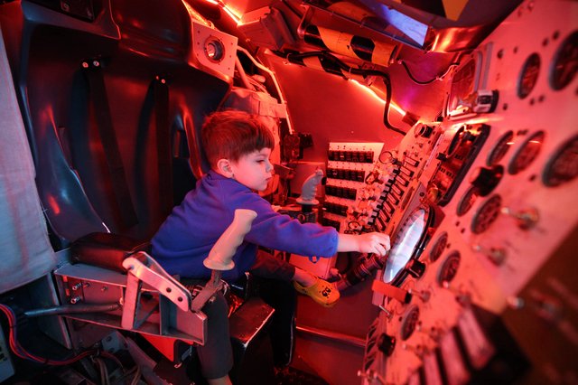 Young Explorer in Submarine Control Room Simulation