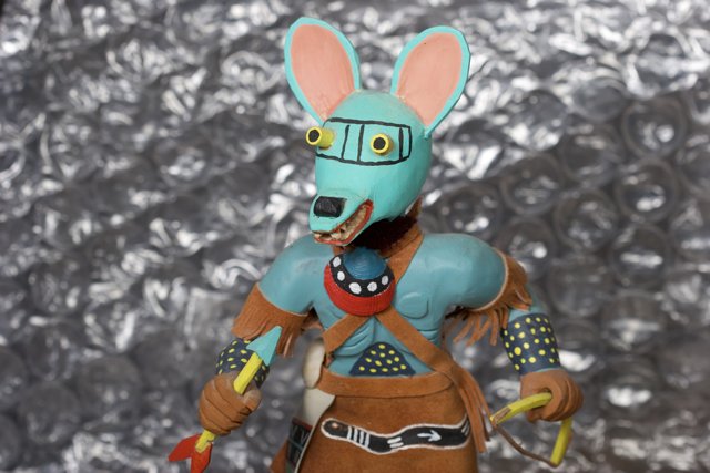 Blue and Orange Rabbit Figurine with a Knife