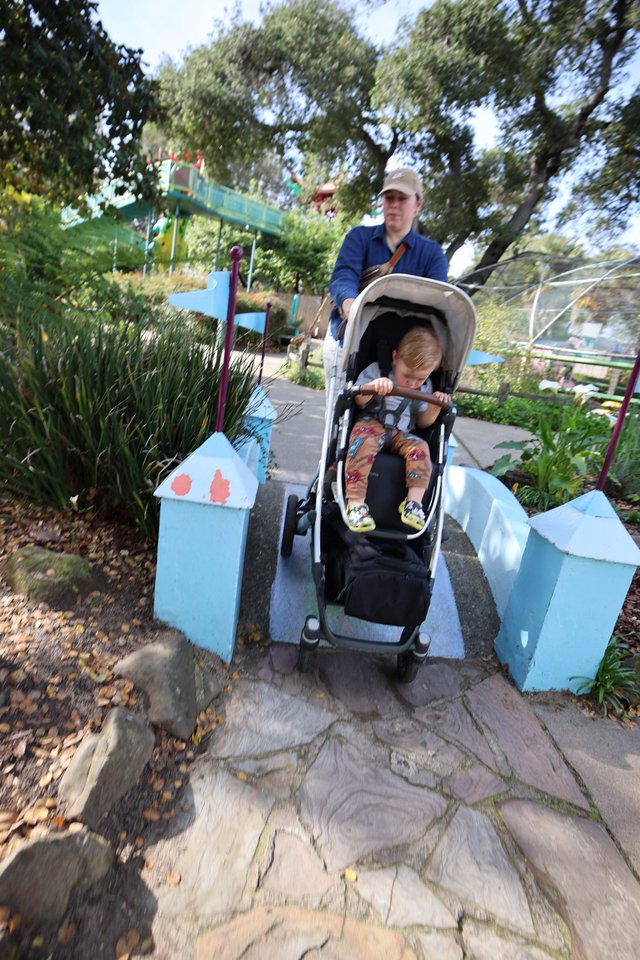 Parent and Child Crossing Miniature Bridge at Fantasyland