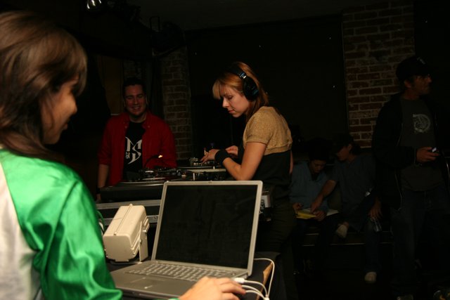 Green Shirted Woman Rocks the DJ Booth