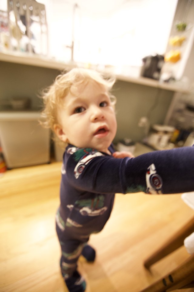 Curious Toddler in Christmas Pajamas Looking Up
