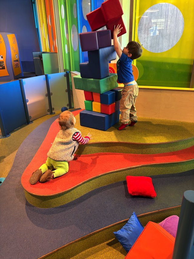 Children Building Tower with Oversized Foam Blocks