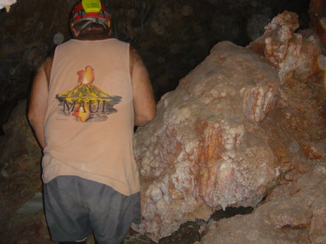 Man Explores Cave in T-Shirt and Hardhat